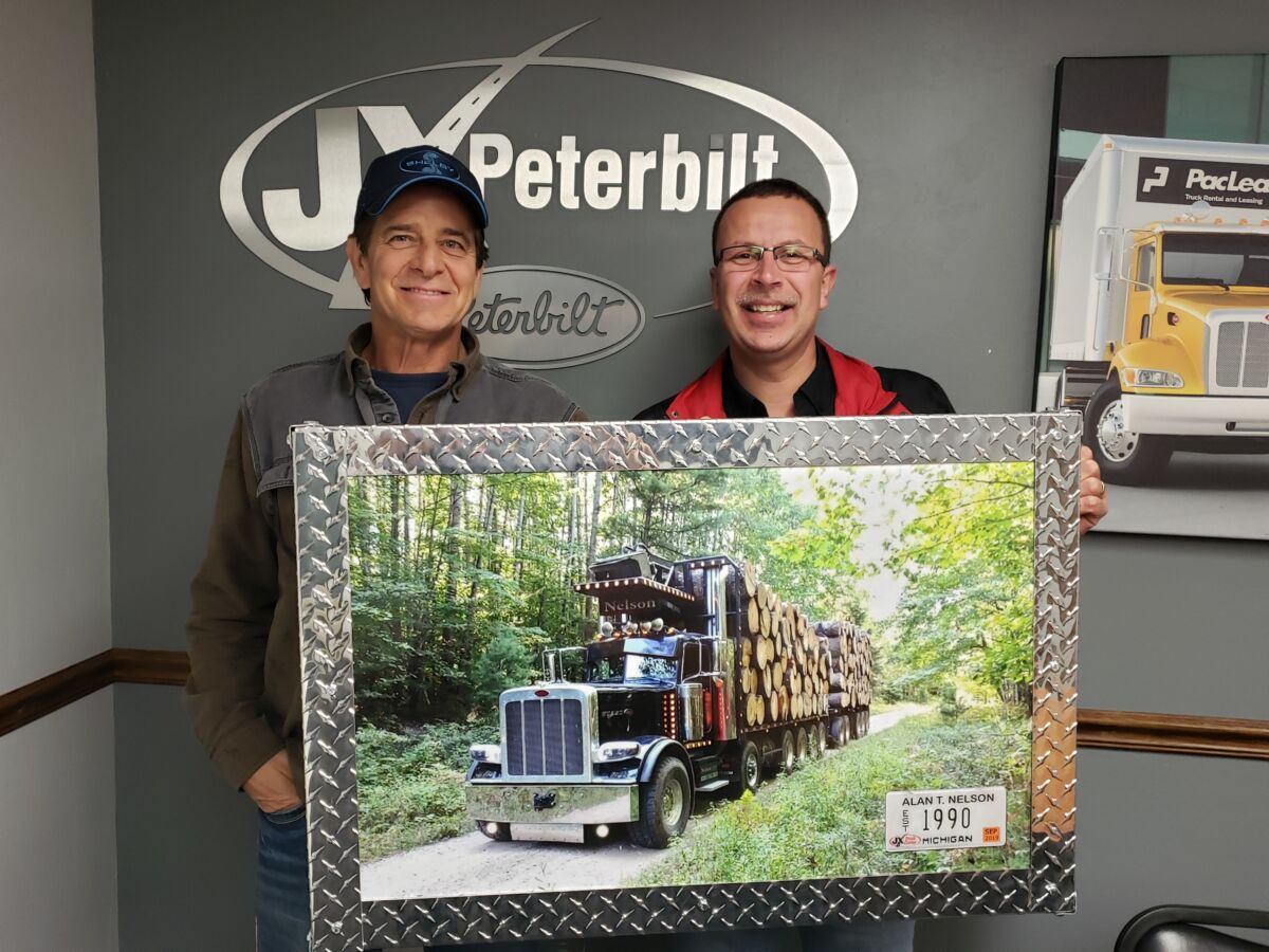 Scott Lemke, JX Sales Executive & Alan Nelson with customer appreciation artwork