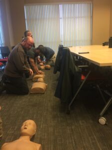 JX Employees practice CPR on dummies