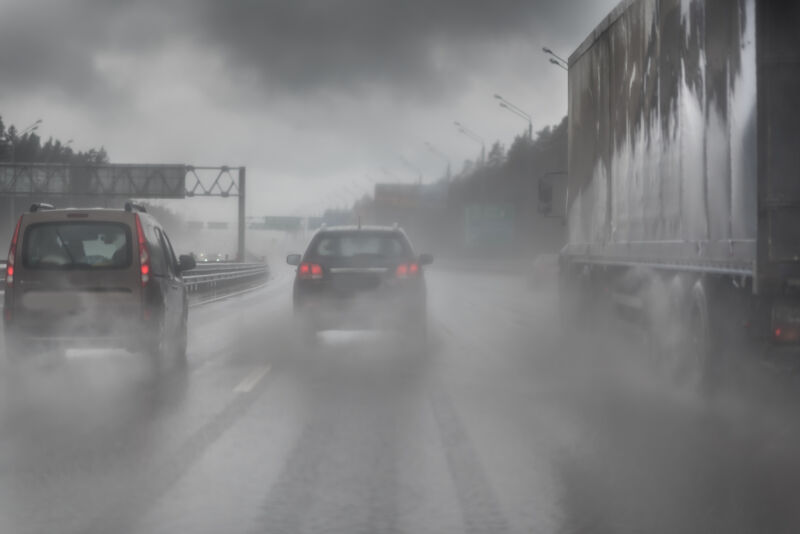 Cars driving along highway through a severe storm