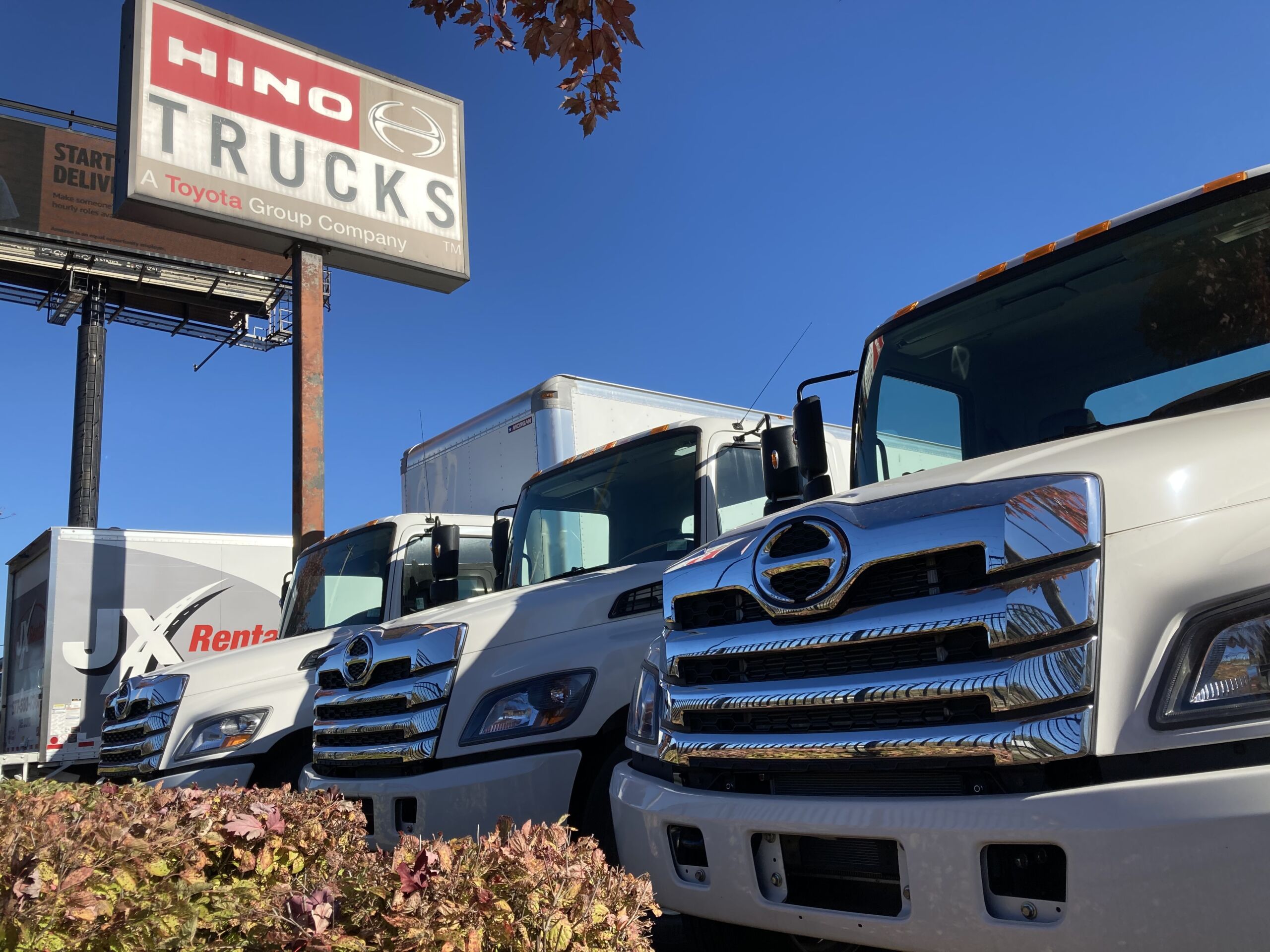 Three Hino Truck s lined up with the hino trucks signage