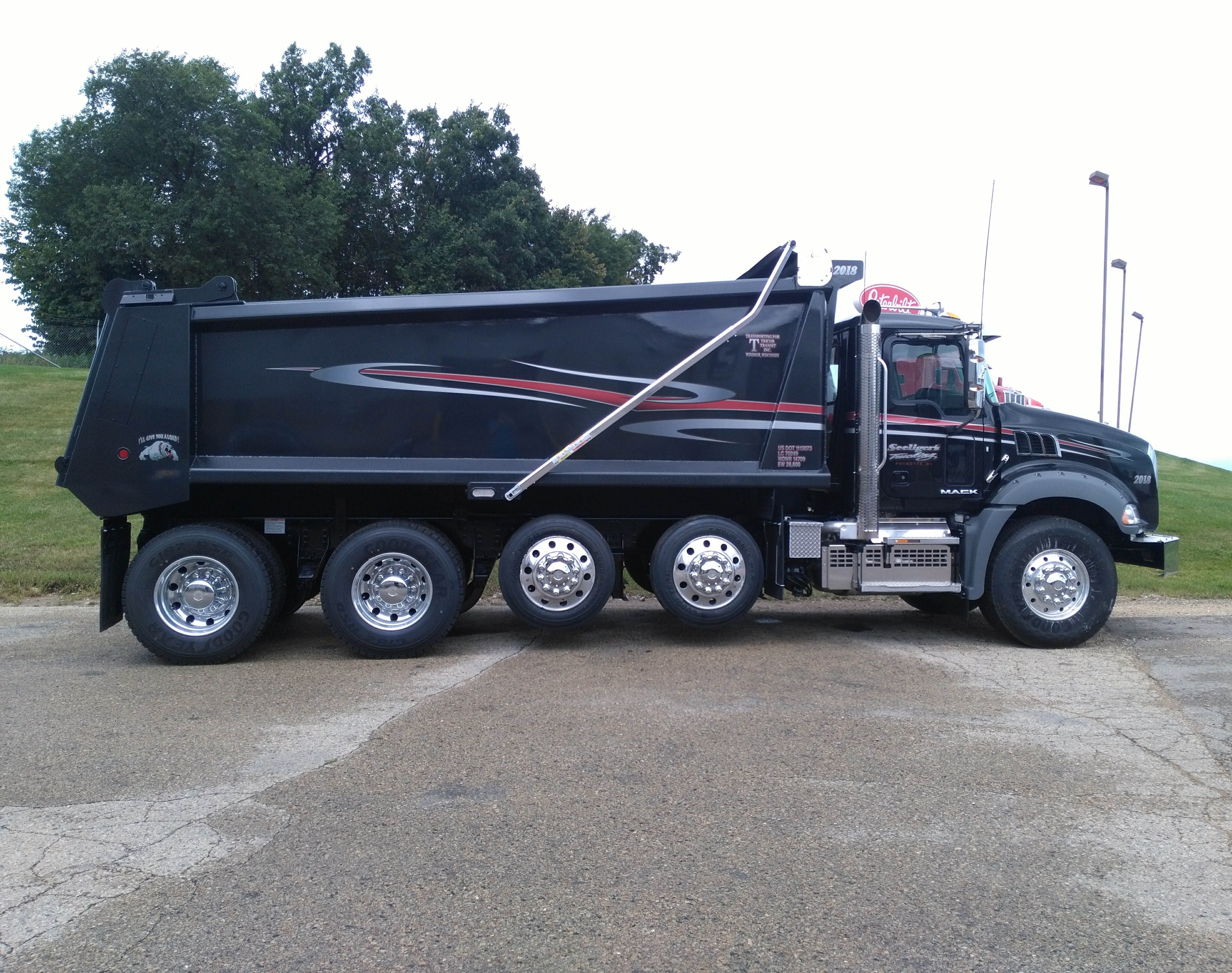 swooping red and silver graphics on dump body truck
