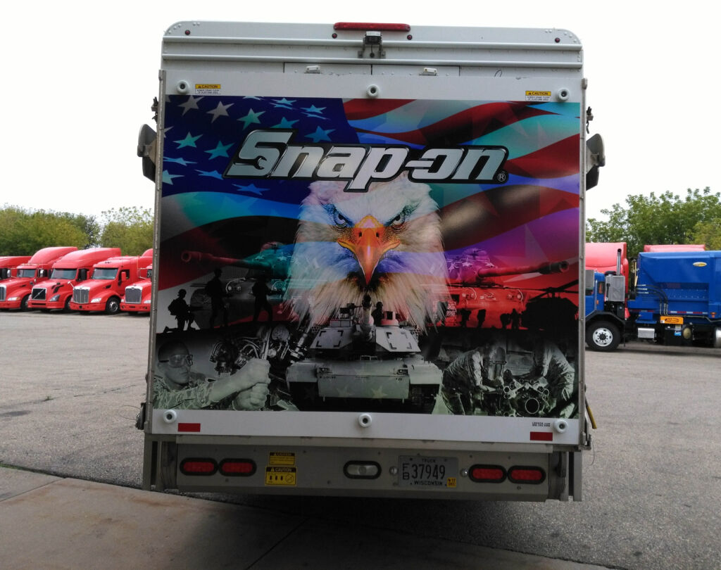 snap-on truck graphic with raindbow american flag, bald eagle, and black and white war images at bottom