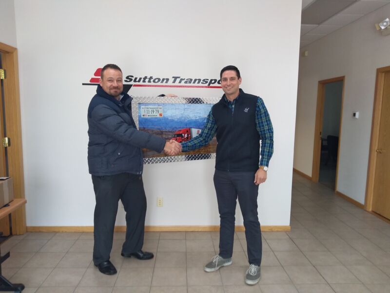 Chris Heinzen – JX Wausau Fleet Account Manager presenting the custom volvo artwork Cliff Sutton from Sutton Transport Inc