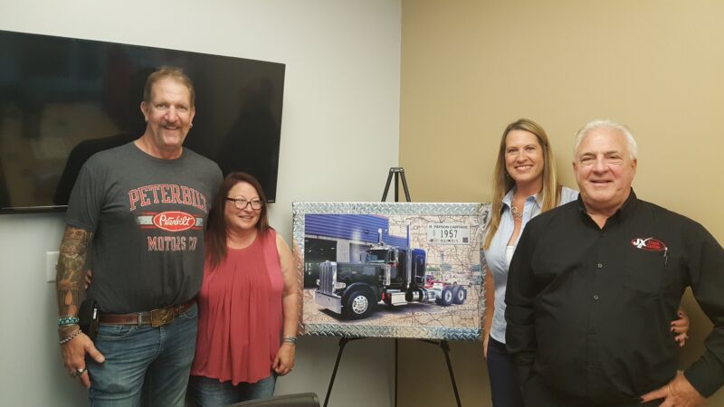 R. Payson Cartage and crew posing with custom artwork from JX