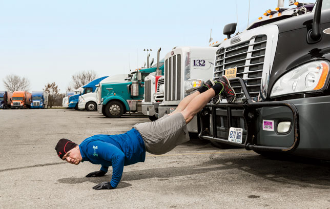 trucker doing pushups on truck