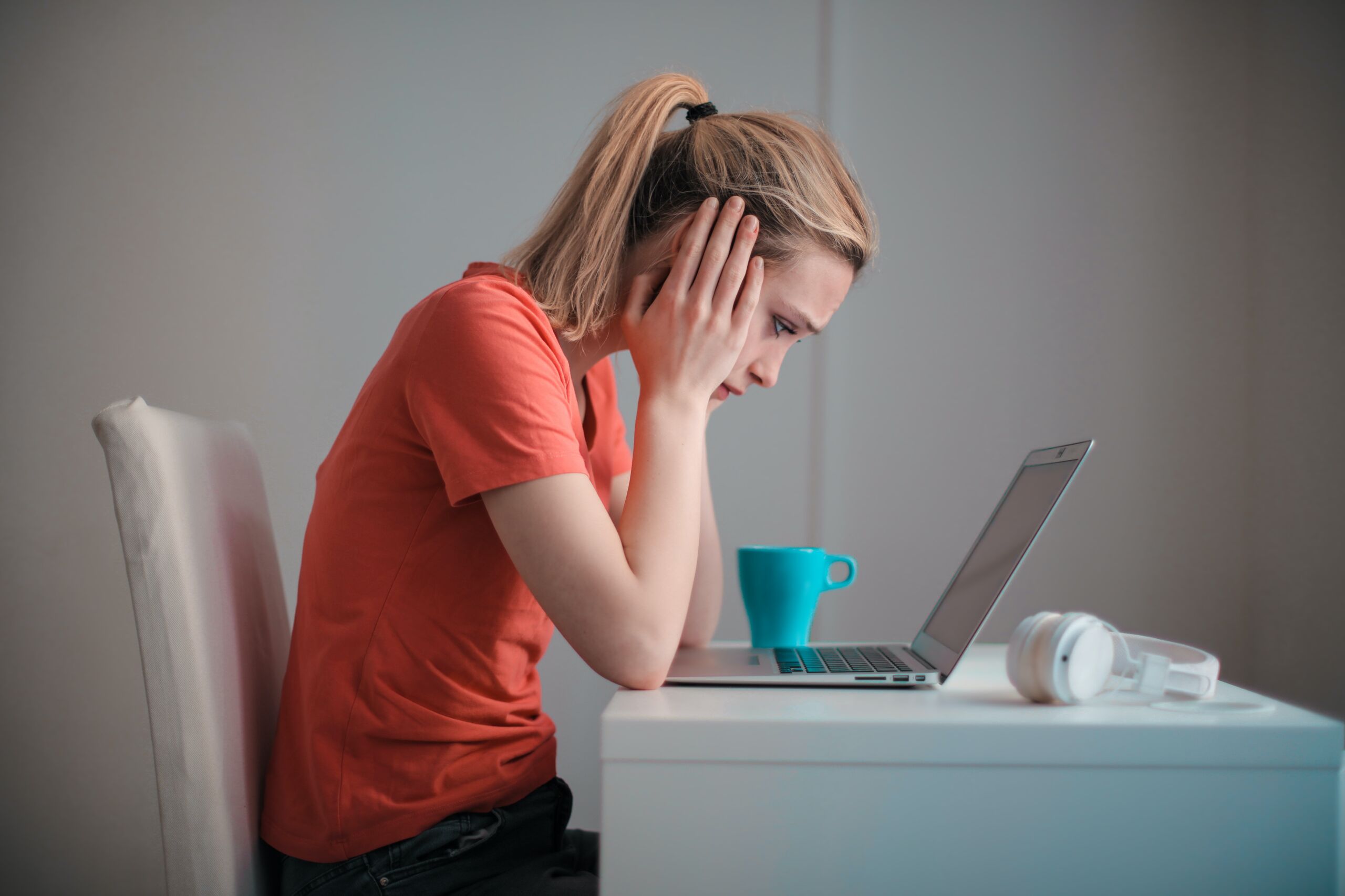 Woman staring at a computer screen considering a job change