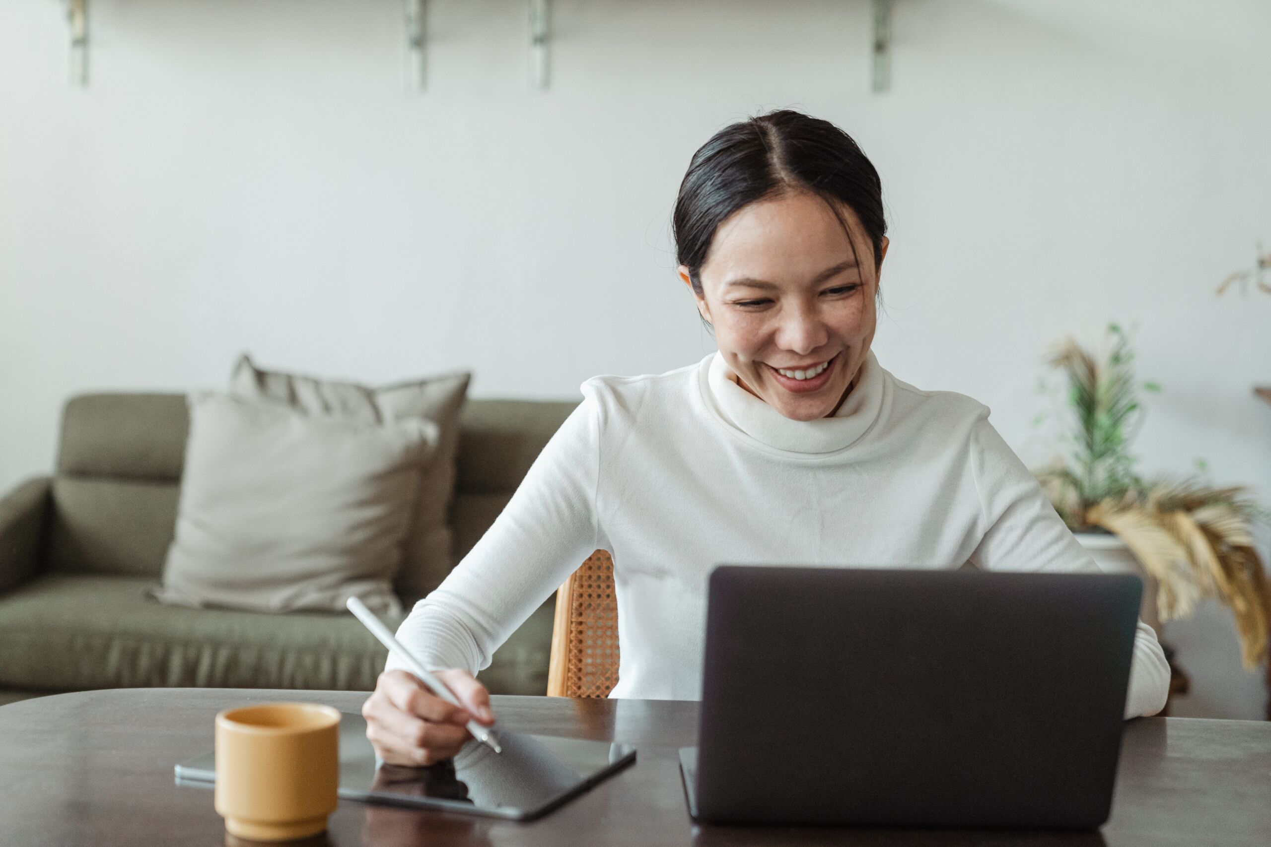 female employee happy and working on laptop setting a Developmental Goal