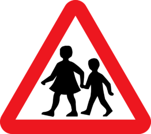 school children crossing street sign