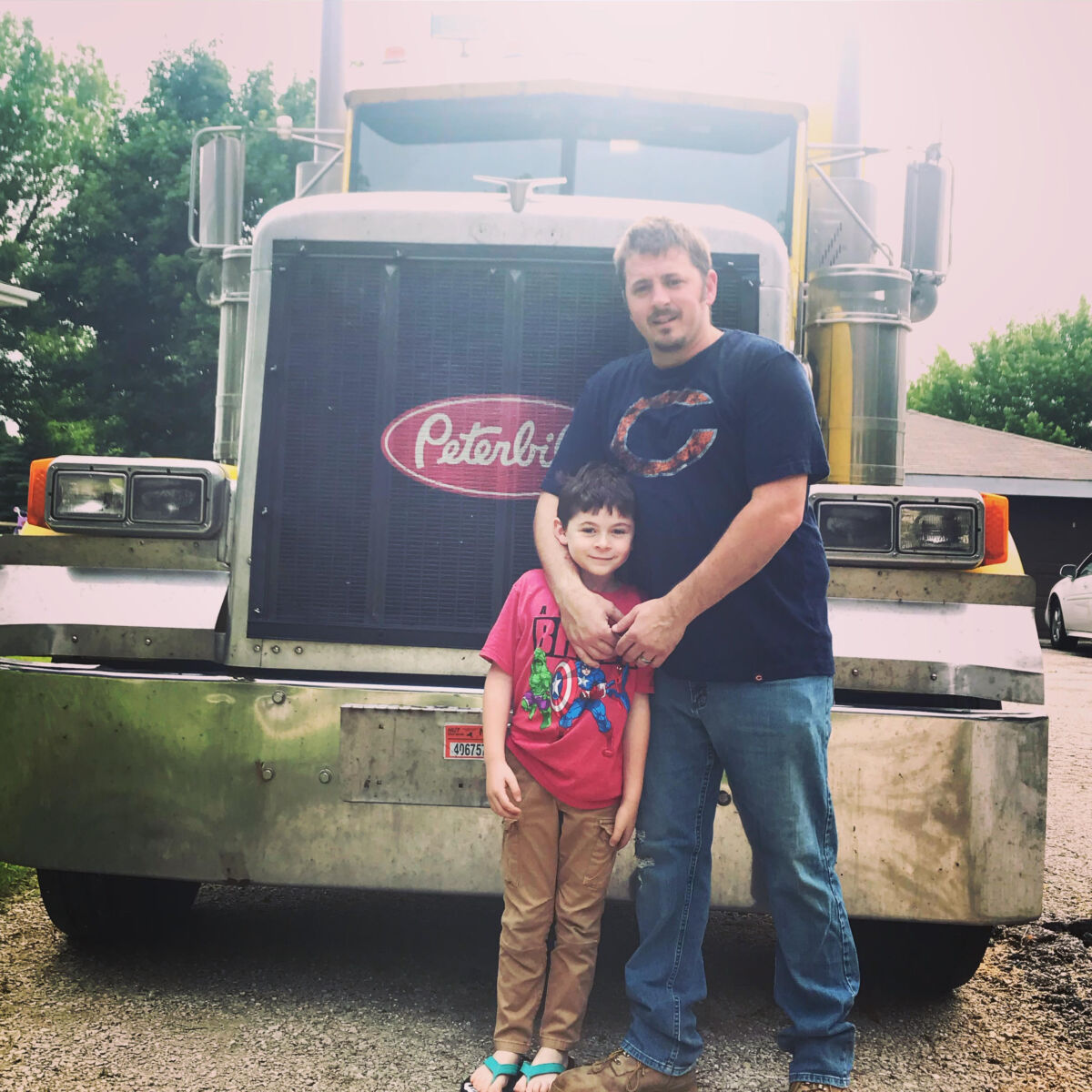 summer road trip with parent and child in a peterbilt semi truck